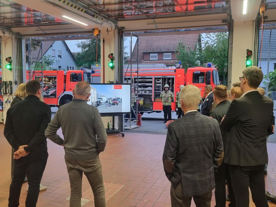 Teilnehmende des Wirtschaftsstammtisches in der Fahrzeughalle der Feuerwehr