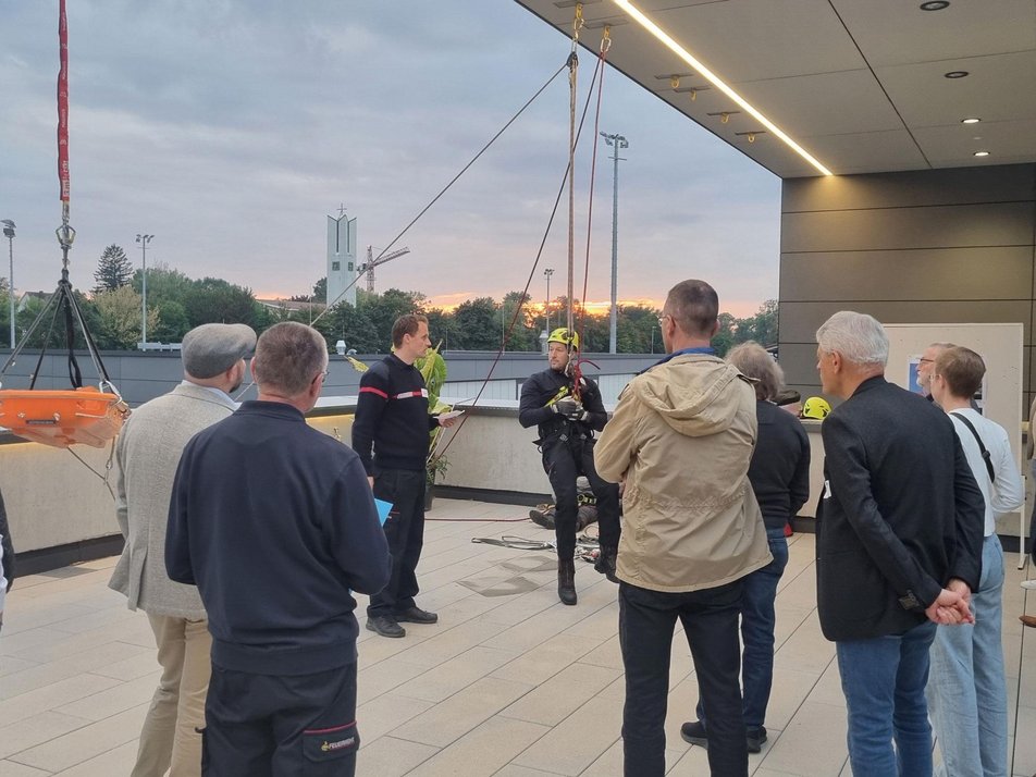 Teilnehmende des Wirtschaftsstammtisches stehen bei Höhenrettung zu